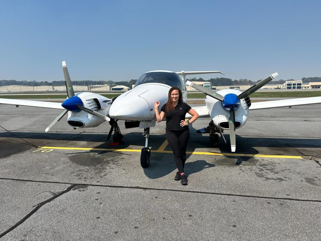 SFS student, Lakisha in front of Diamond DA42 after completing Multi Engine 