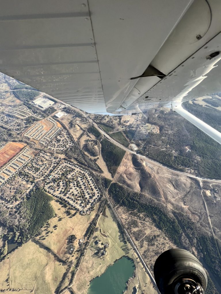 wing view of the ground from an airplane 