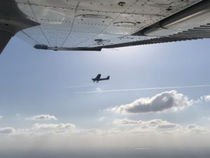 wing shot overlooking fly Cessna