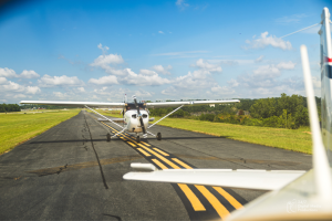 two white Cessna 172 airplanes sitting on a runway