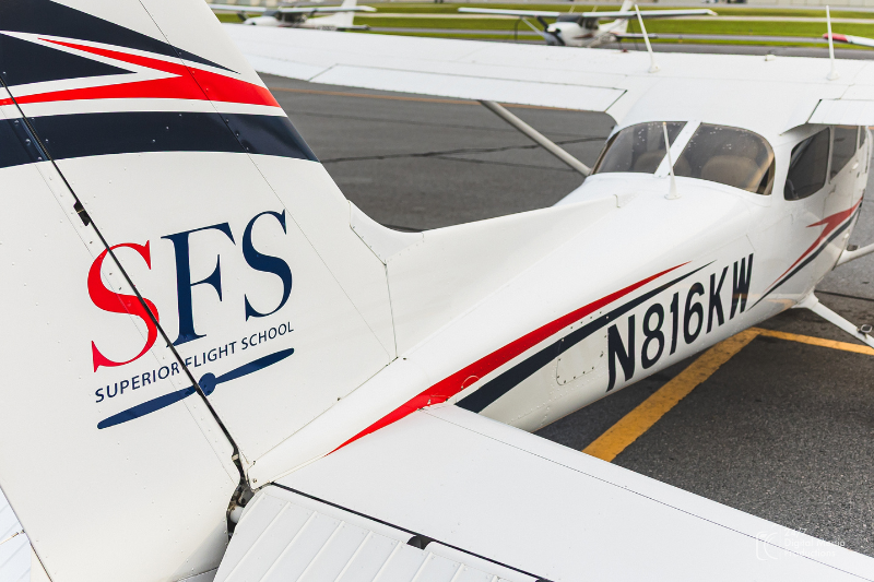 Red white and blue cessna 172 airplane with SFS on the tail