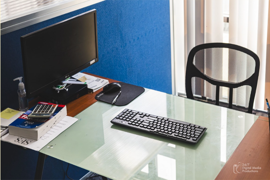 Briefing room with desk and computer and keyboard with an office chair